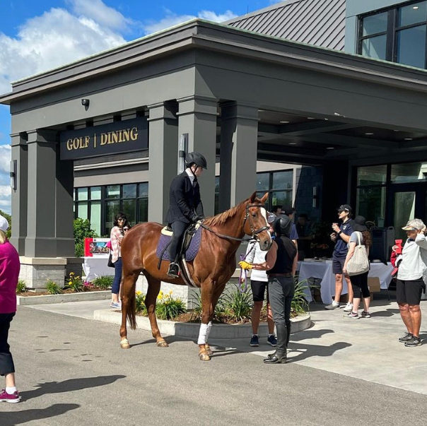 A rider in formal show closed mounted on Lady in front of the MontHill Clubhouse.