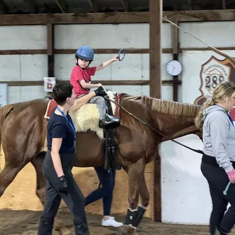 Child on horse doing exercise